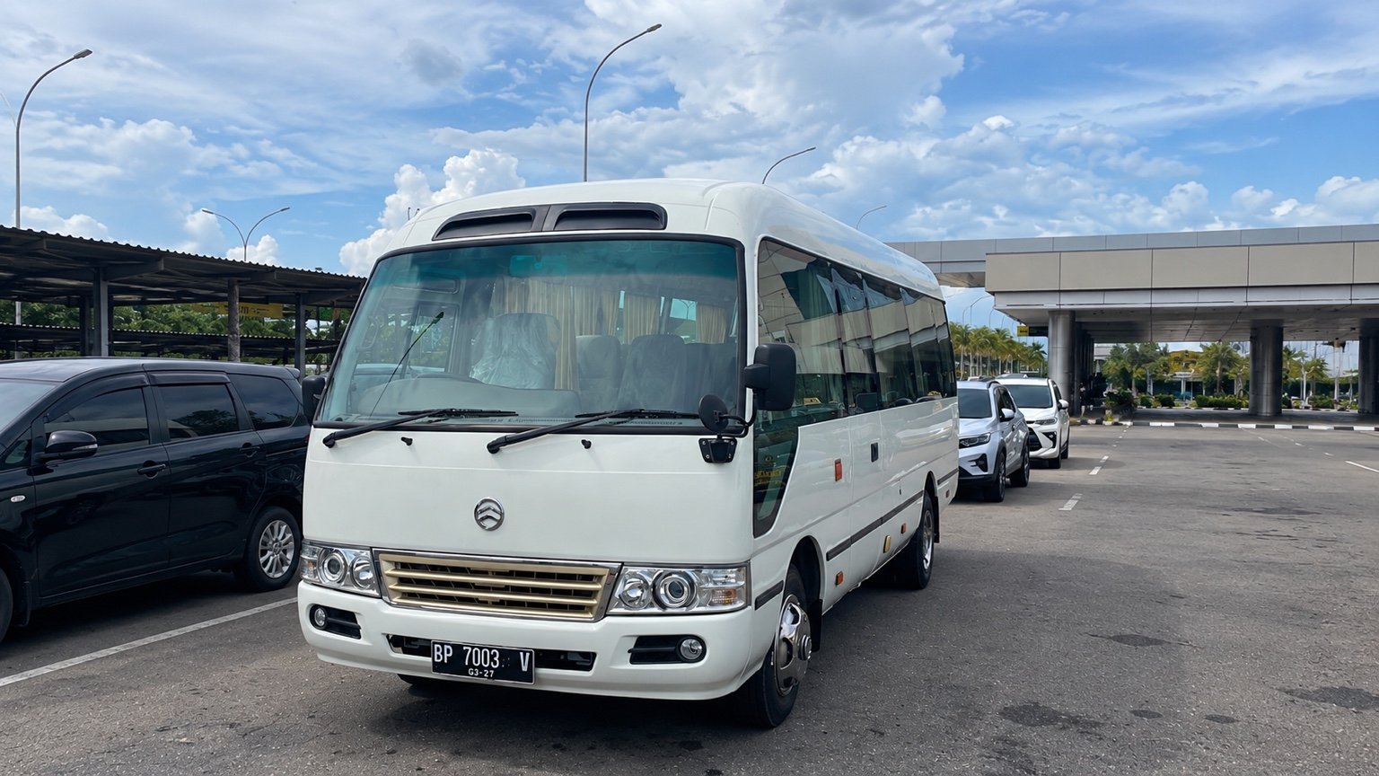Minibus putih di area penjemputan Batam.