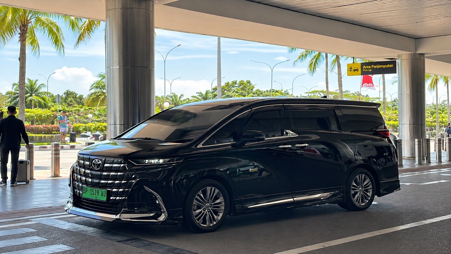Original black Toyota Alphard at an airport pickup area in Batam